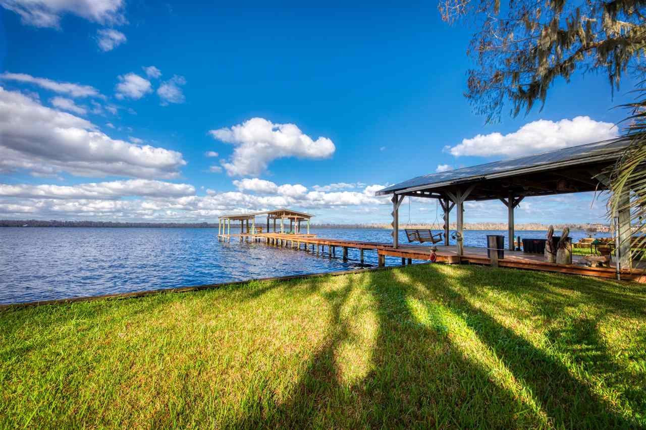 a view of a swimming pool with an outdoor seating and a yard