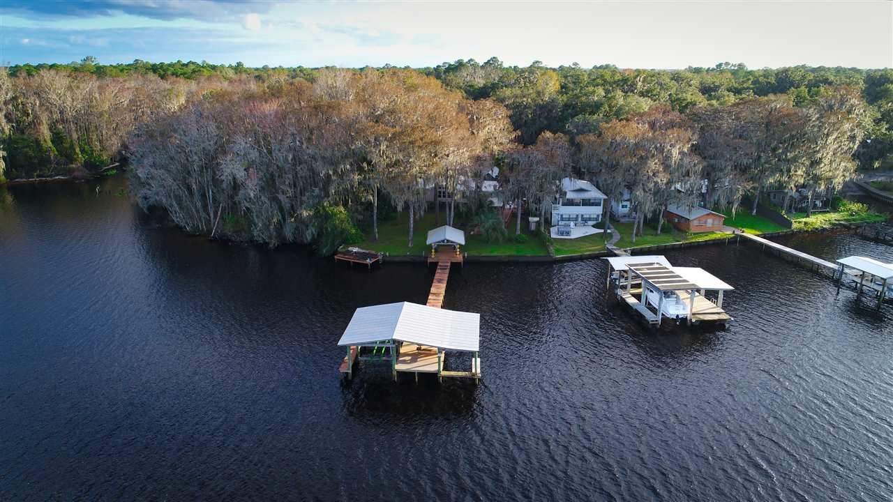 8580 G Palmo Fish Camp Road St. Augustine, FL 32092 - Photo 19 of 48 an outdoor sitting area with swimming pool and green space