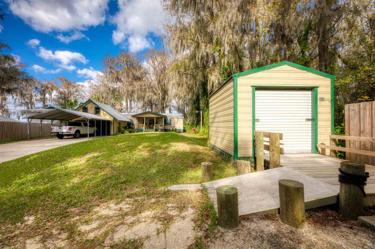 8580 G Palmo Fish Camp Road St. Augustine, FL 32092 - Photo 28 of 48 a front view of a house with a yard