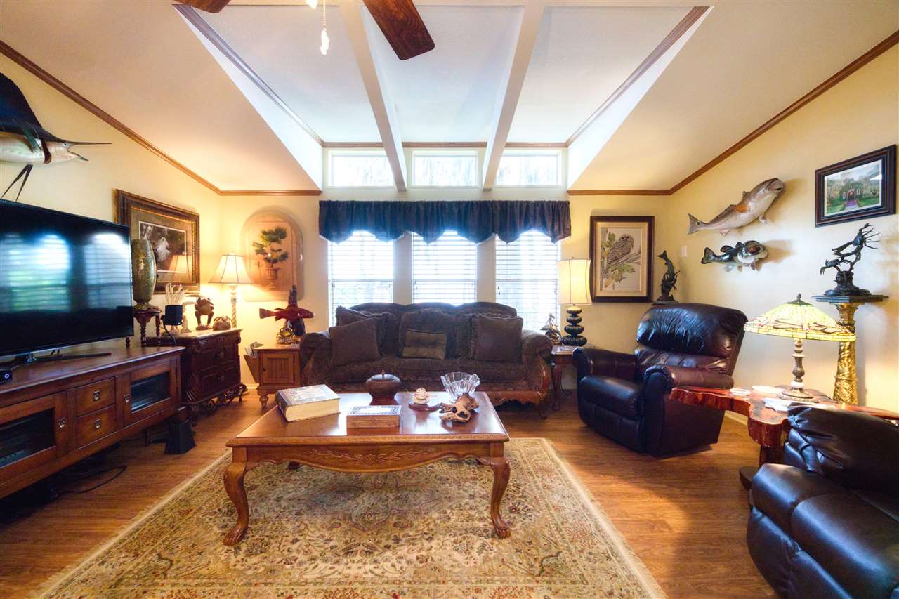 8580 G Palmo Fish Camp Road St. Augustine, FL 32092 - Photo 34 of 48 a living room with furniture and a flat screen tv