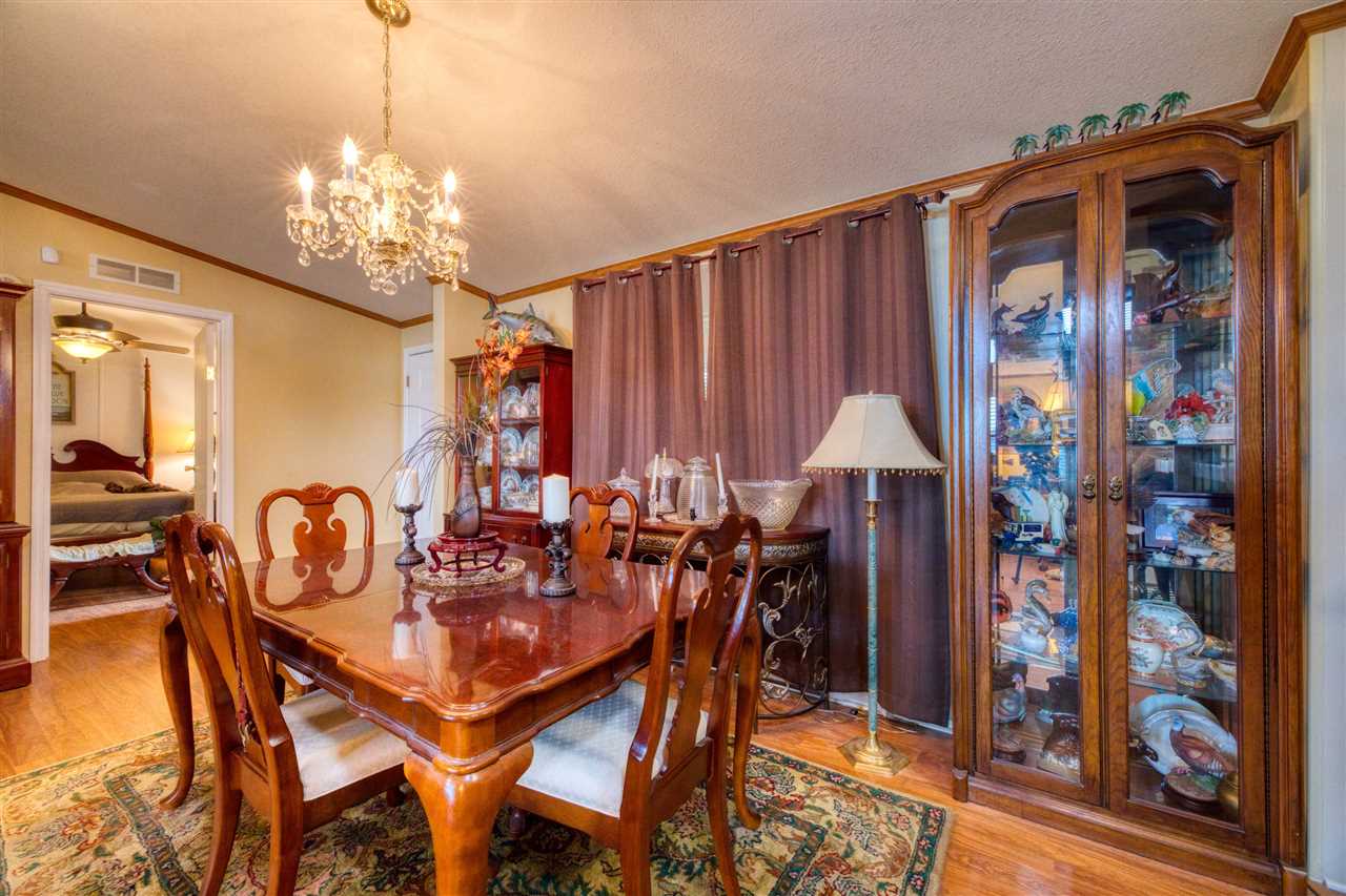 8580 G Palmo Fish Camp Road St. Augustine, FL 32092 - Photo 36 of 48 a view of a dining room with furniture and chandelier