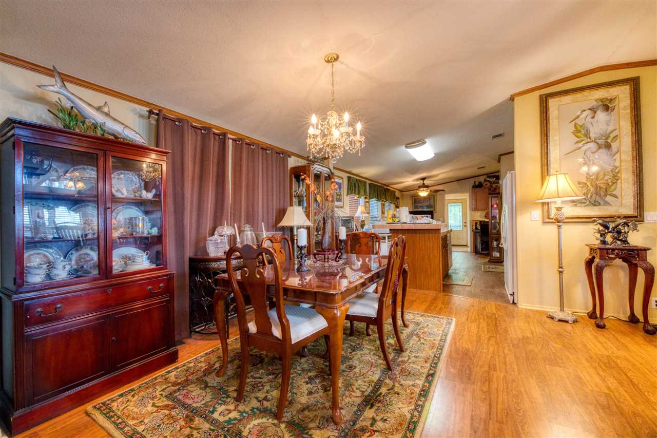 8580 G Palmo Fish Camp Road St. Augustine, FL 32092 - Photo 37 of 48 a view of a dining room with furniture and chandelier