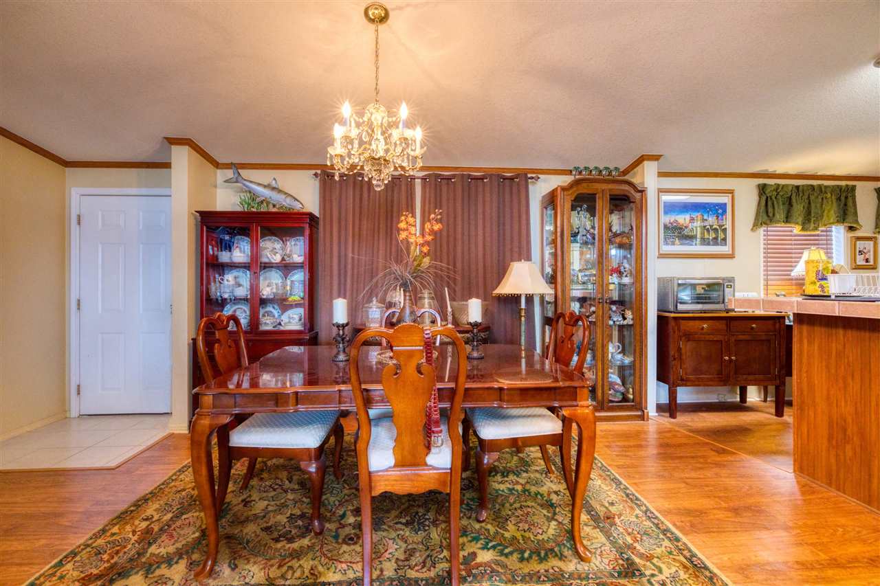 8580 G Palmo Fish Camp Road St. Augustine, FL 32092 - Photo 38 of 48 a view of a dining room with furniture and chandelier