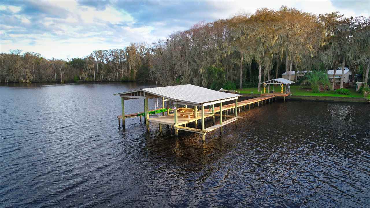 8580 G Palmo Fish Camp Road St. Augustine, FL 32092 - Photo 4 of 48 a swimming pool with trees in the background