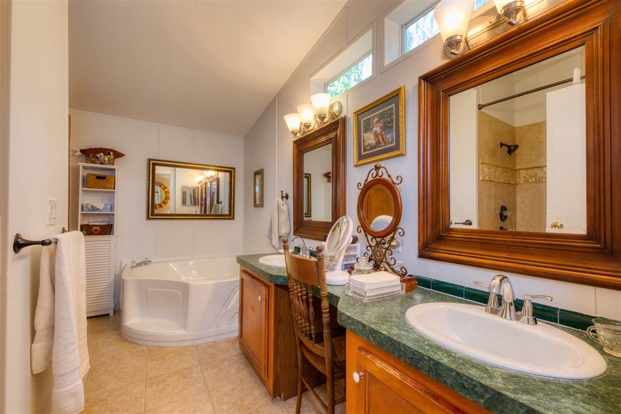 8580 G Palmo Fish Camp Road St. Augustine, FL 32092 - Photo 43 of 48 a bathroom with a granite countertop sink and a mirror