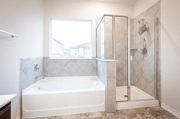a bathroom with a bathtub shower sink and toilet