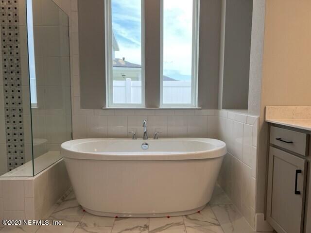 60 Pine Forest Court St. Augustine, FL 32092 - Photo 11 of 26 a white bath tub sitting in a bathroom