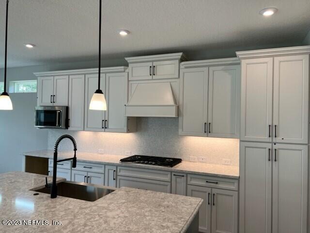 60 Pine Forest Court St. Augustine, FL 32092 - Photo 2 of 26 a kitchen with granite countertop a stove a sink and a microwave