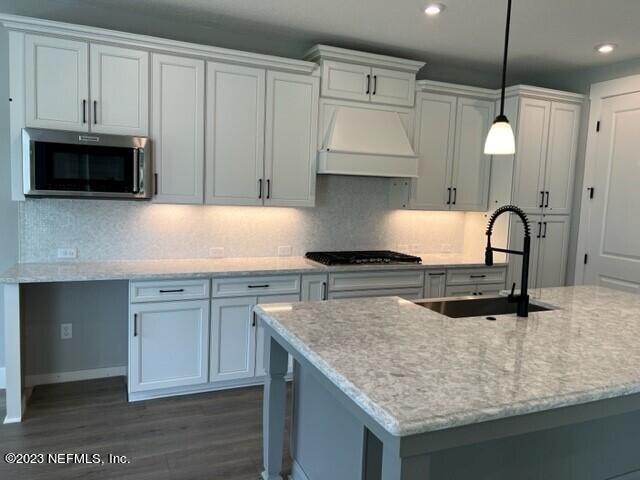 60 Pine Forest Court St. Augustine, FL 32092 - Photo 3 of 26 a kitchen with granite countertop a sink a stove and a microwave