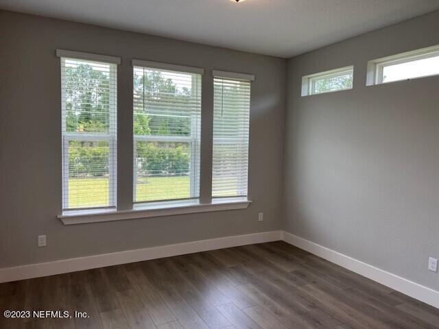 60 Pine Forest Court St. Augustine, FL 32092 - Photo 6 of 26 a view of an empty room with wooden floor and a window