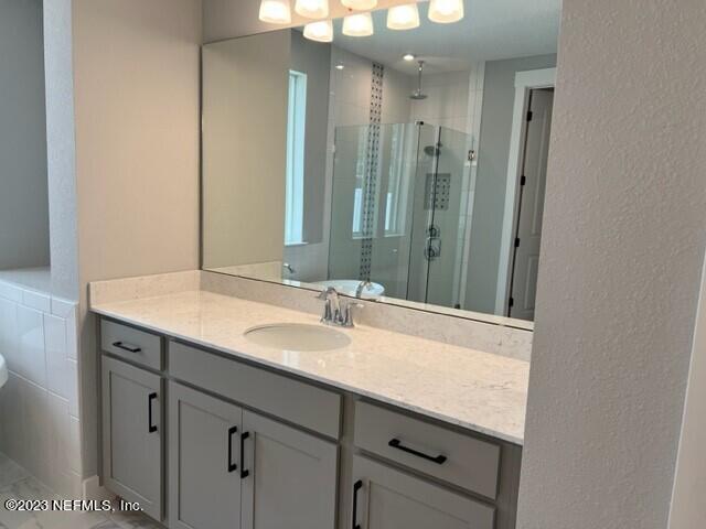 60 Pine Forest Court St. Augustine, FL 32092 - Photo 9 of 26 a bathroom with a granite countertop sink and a mirror