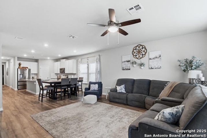 232 Colebrook Way Cibolo, TX 78108 - Photo 13 of 36 a living room with furniture kitchen view and a large window