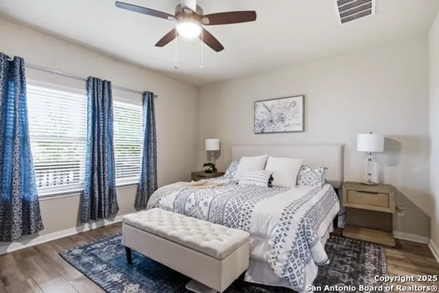 a bedroom with a bed and wooden floor