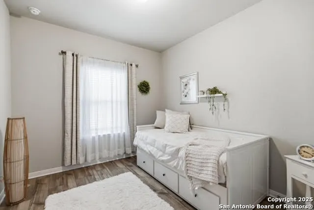 a bedroom with a bed and a mirror