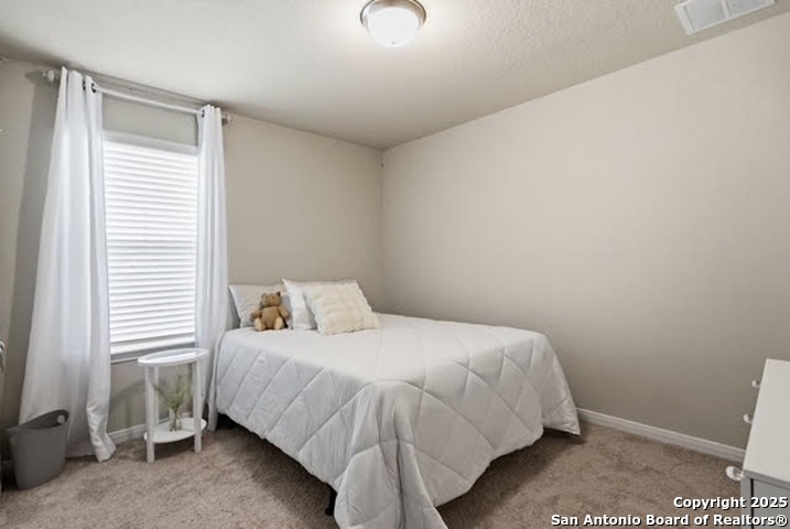 232 Colebrook Way Cibolo, TX 78108 - Photo 25 of 36 a bedroom with a bed and a window