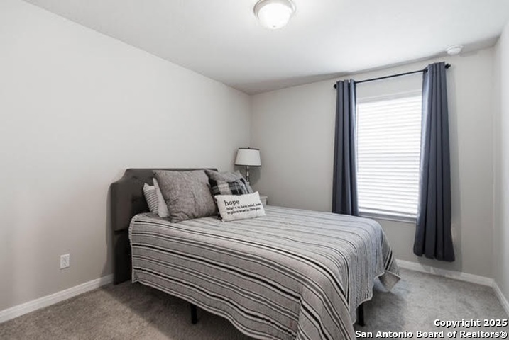 232 Colebrook Way Cibolo, TX 78108 - Photo 27 of 36 a bedroom with a bed and a window