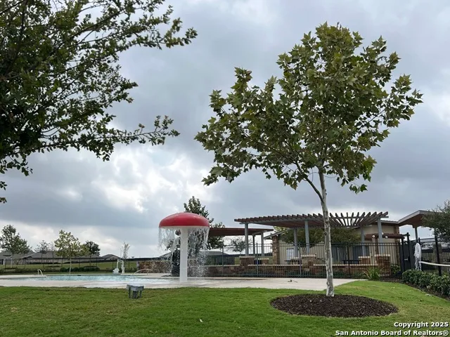 a view of a swimming pool with a yard