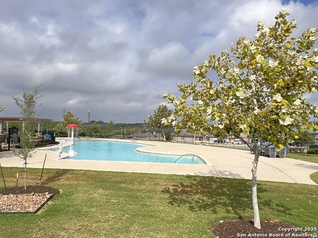 232 Colebrook Way Cibolo, TX 78108 - Photo 33 of 36 a view of a swimming pool with a yard