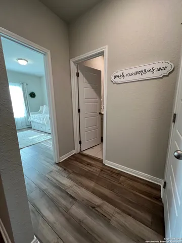 a view of a hallway with wooden floor