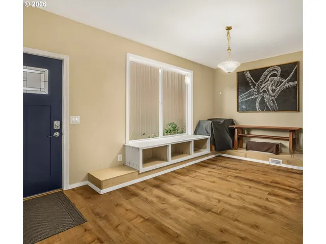a living room with furniture a floor to ceiling window and a fireplace