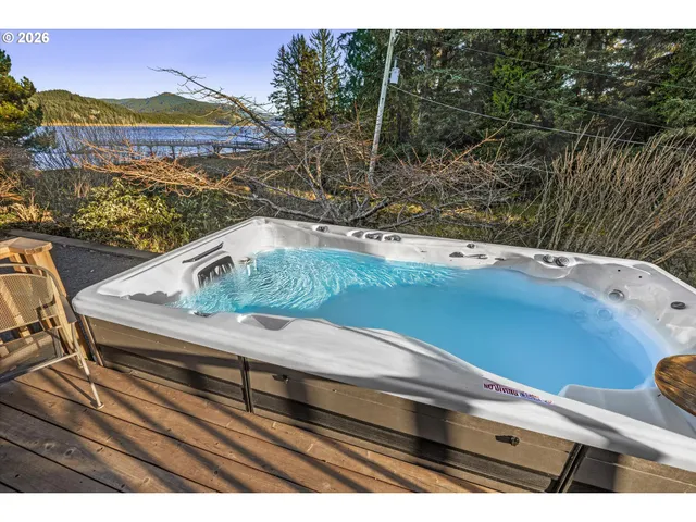 a kitchen with stainless steel appliances granite countertop a sink a stove a refrigerator and a cabinets