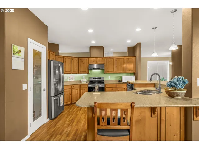 a kitchen with refrigerator a mirror and cabinets