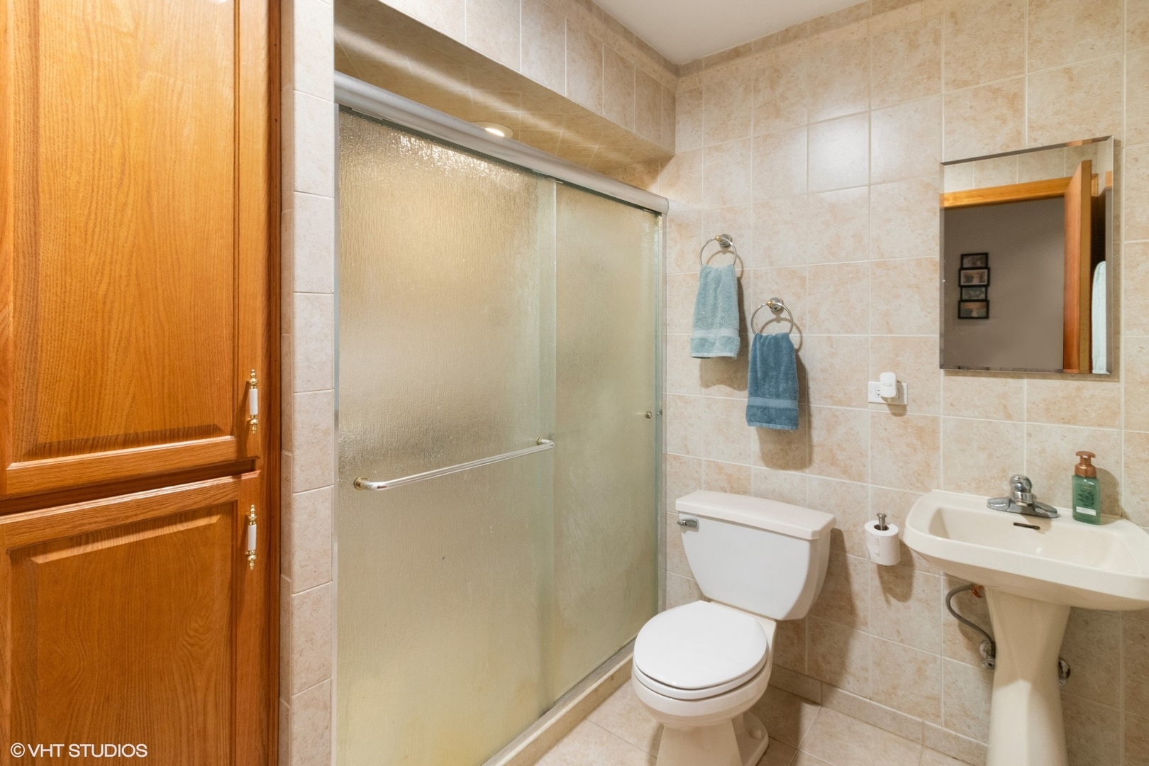 247 South Church Road Bensenville, IL 60106 - Photo 7 of 18 a white toilet sitting next to a bathroom sink and a mirror