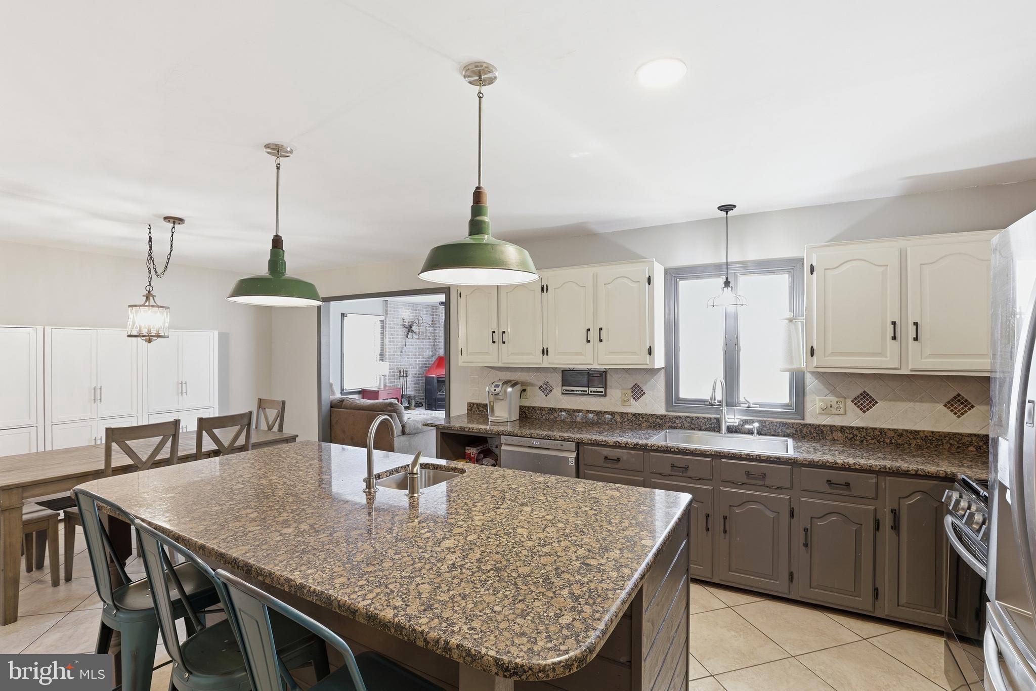 228 Firetower Road Camden Wyoming, DE 19934 - Photo 15 of 39 a kitchen with stainless steel appliances granite countertop a sink a center island and cabinets