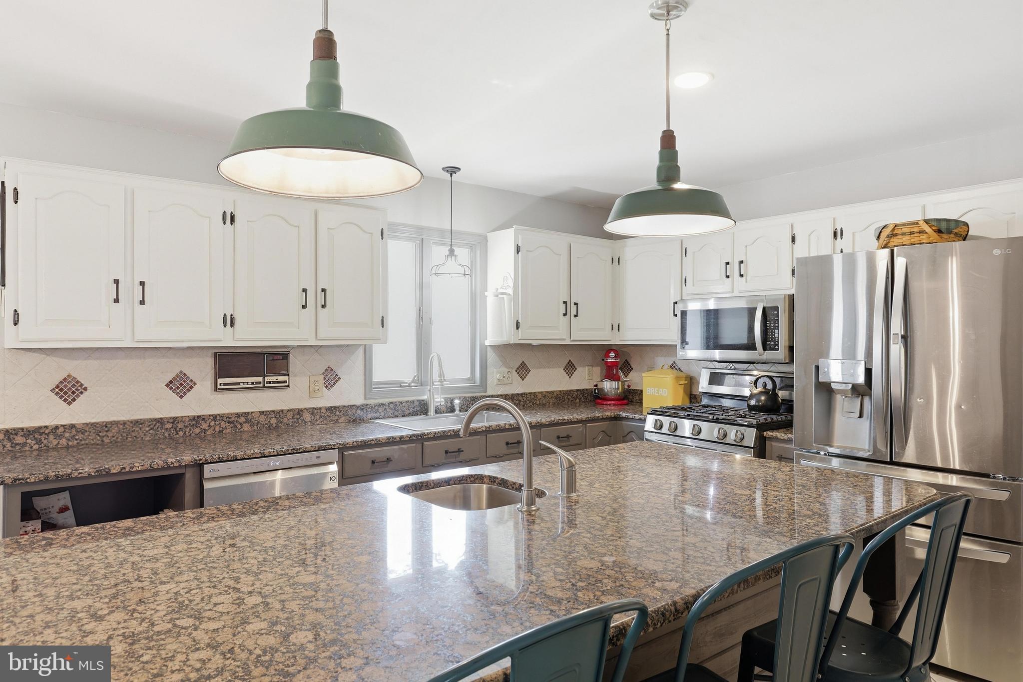 228 Firetower Road Camden Wyoming, DE 19934 - Photo 16 of 39 a kitchen with stainless steel appliances granite countertop a sink a stove and a refrigerator