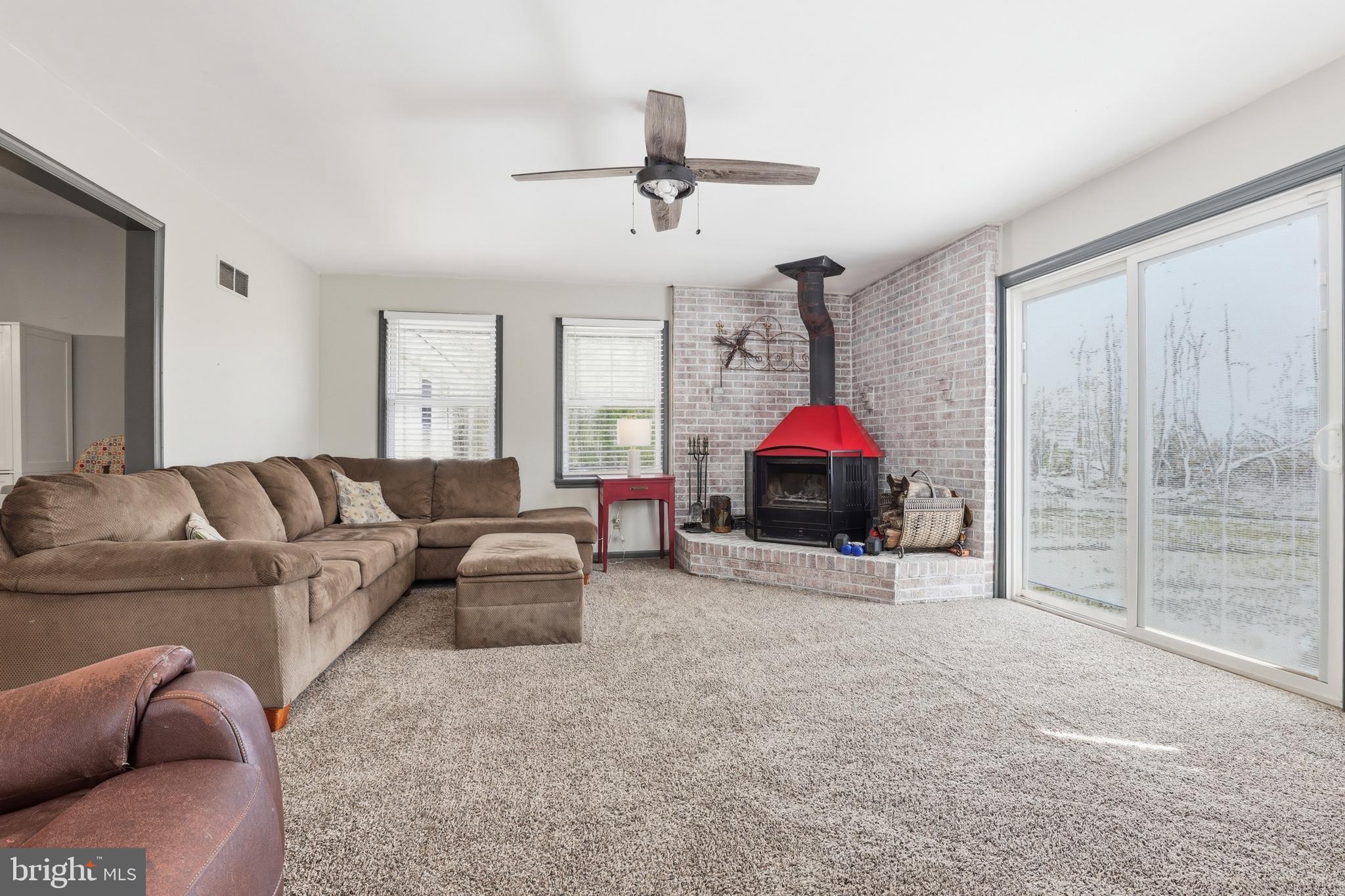 228 Firetower Road Camden Wyoming, DE 19934 - Photo 18 of 39 a living room with furniture ceiling fan and a rug