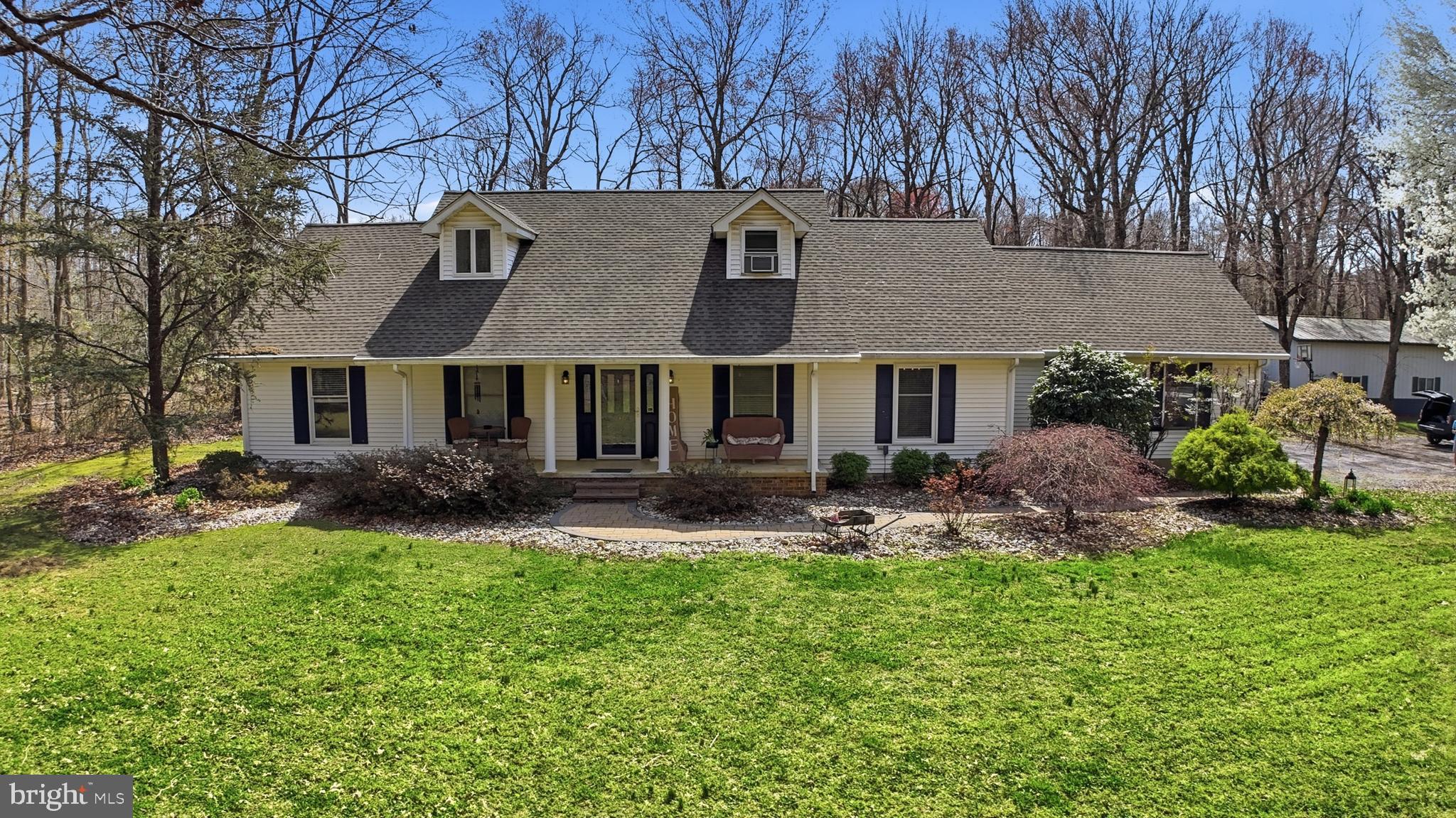 228 Firetower Road Camden Wyoming, DE 19934 - Photo 5 of 39 a front view of a house with garden and patio