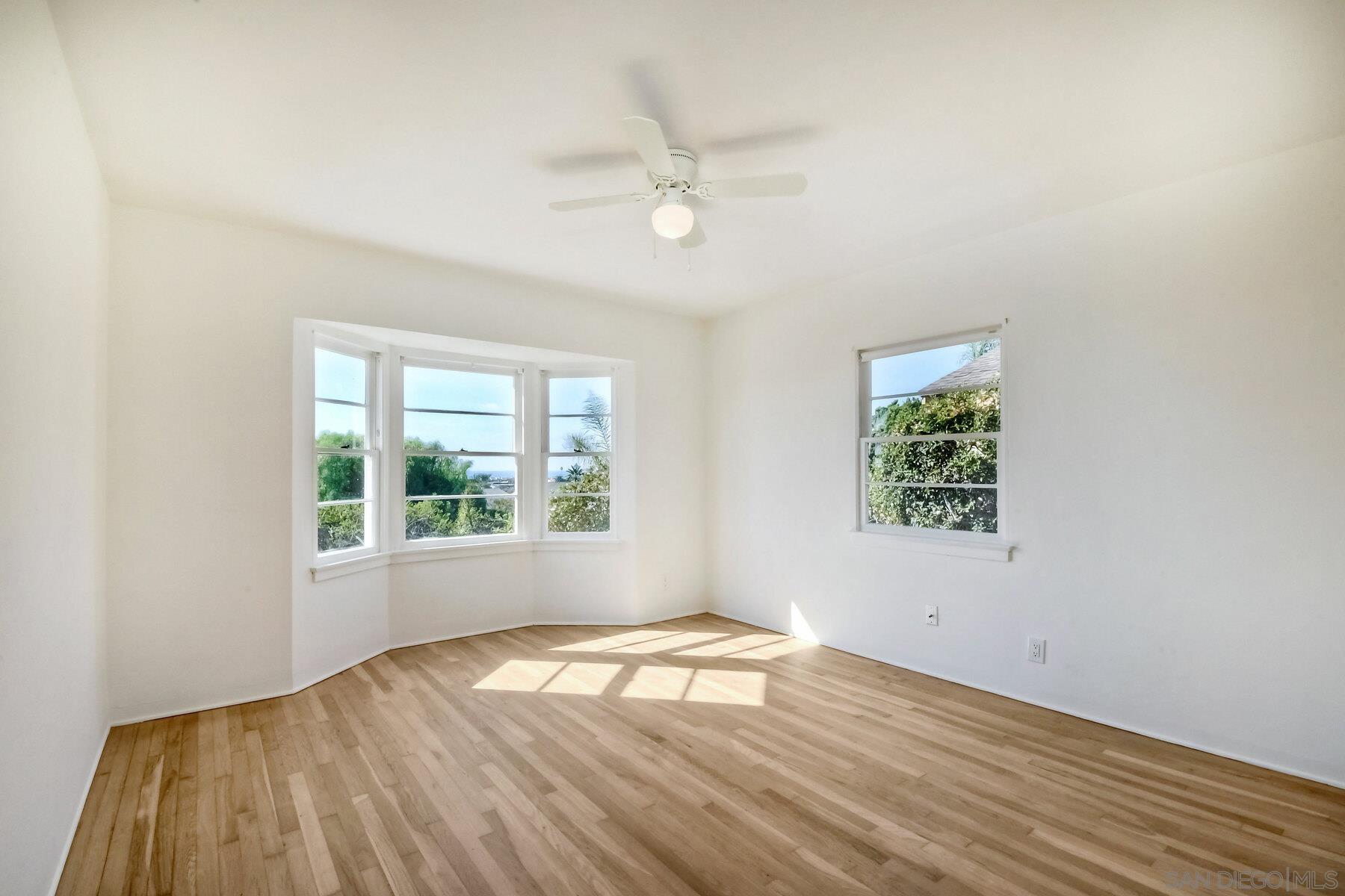855 Dewitt Avenue Encinitas, CA 92024 - Photo 19 of 23 an empty room with wooden floor and windows