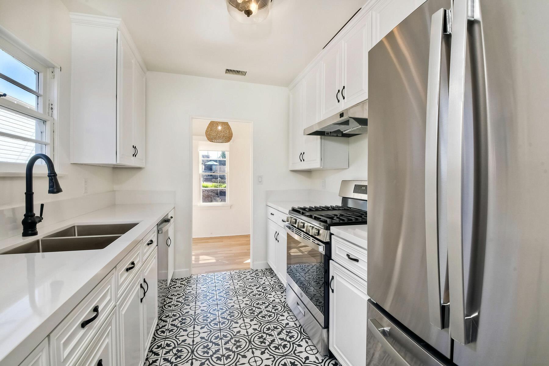 855 Dewitt Avenue Encinitas, CA 92024 - Photo 10 of 23 a kitchen with stainless steel appliances granite countertop a sink stove and refrigerator