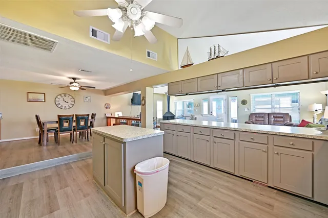 a kitchen with sink cabinets and wooden floor