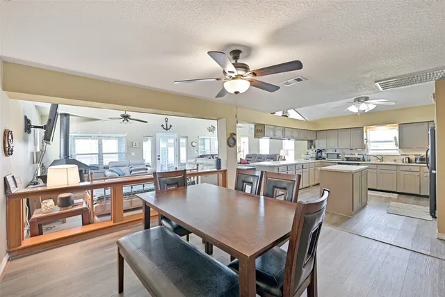 a view of a dining room with furniture a chandelier and wooden floor
