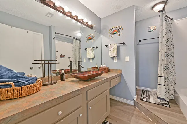 a spacious bathroom with double vanity and a mirror