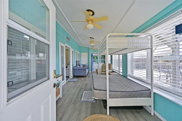 a dining room with furniture and a floor to ceiling window
