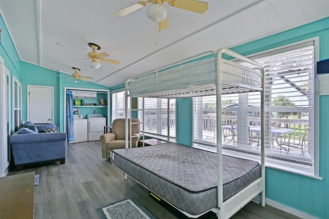 a bedroom with a large bed and a large window