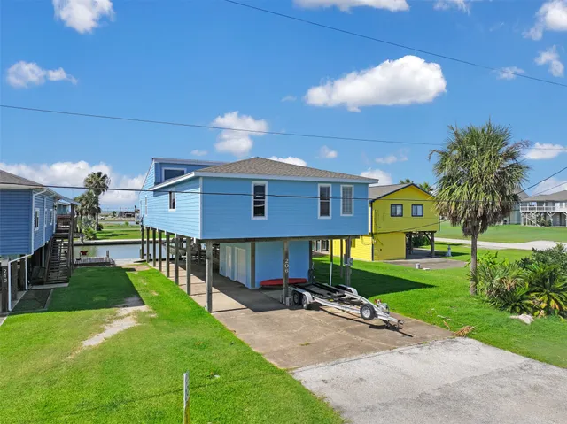 a view of a swimming pool with a yard in front of it