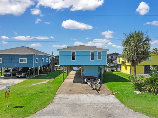 a front view of a house with yard and green space