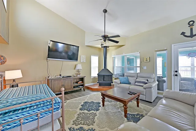 a living room with furniture a rug and a flat screen tv