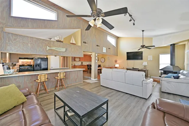 a living room with furniture and kitchen view