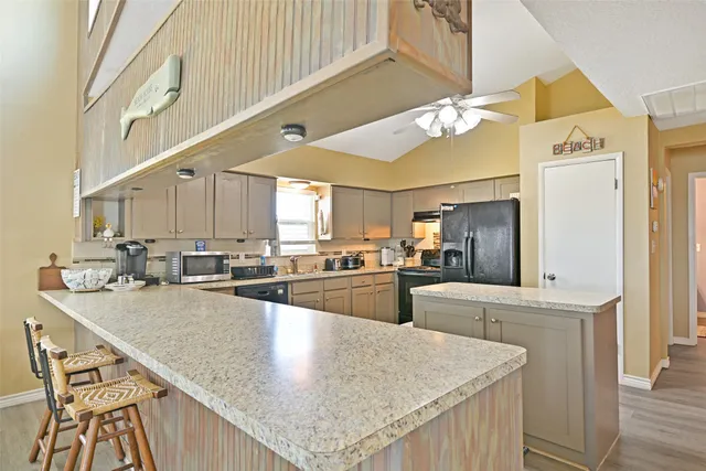 a kitchen with stainless steel appliances granite countertop a sink counter space and cabinets