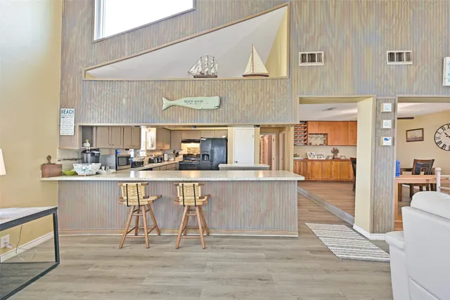 a kitchen with stainless steel appliances granite countertop a white cabinets and stove top oven
