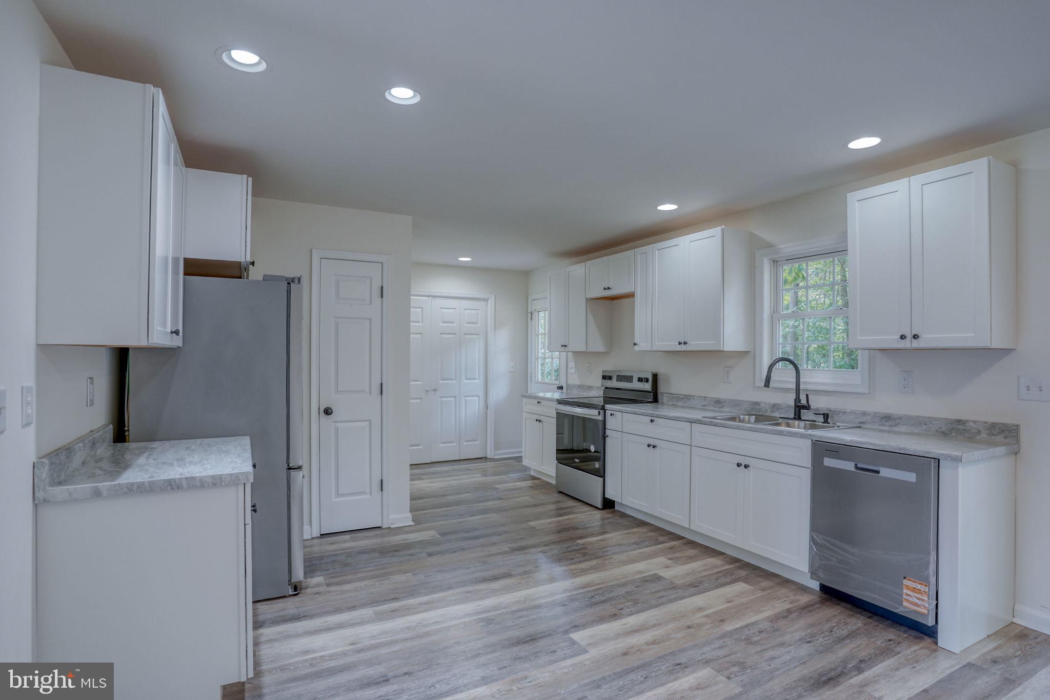 23678 Willow Pond Road Denton, MD 21629 - Photo 16 of 51 a kitchen with a sink cabinets and wooden floor