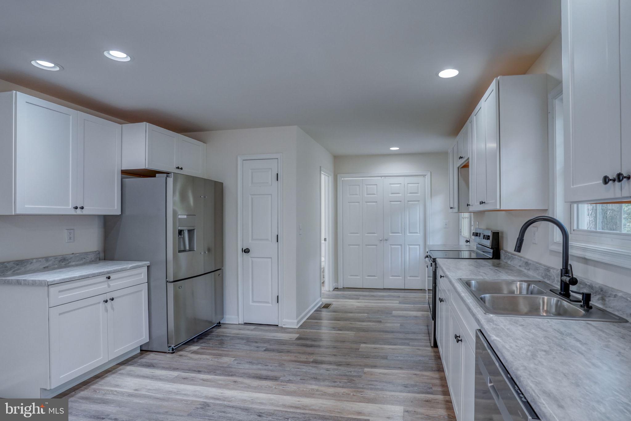 23678 Willow Pond Road Denton, MD 21629 - Photo 19 of 51 a kitchen with a refrigerator sink and cabinets