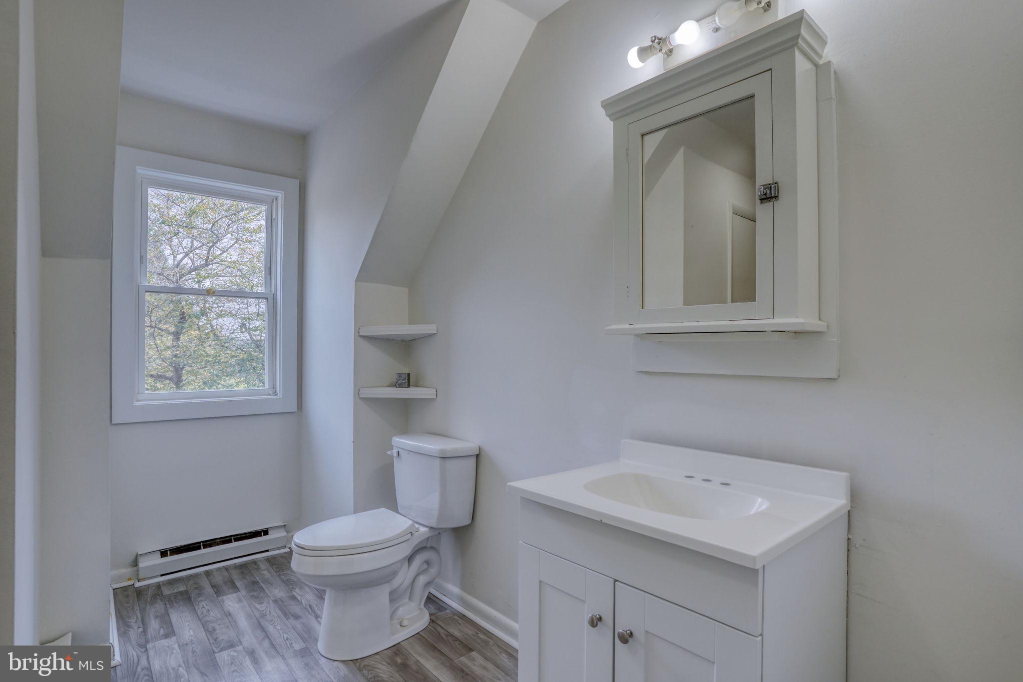 23678 Willow Pond Road Denton, MD 21629 - Photo 42 of 51 a bathroom with a toilet sink and mirror
