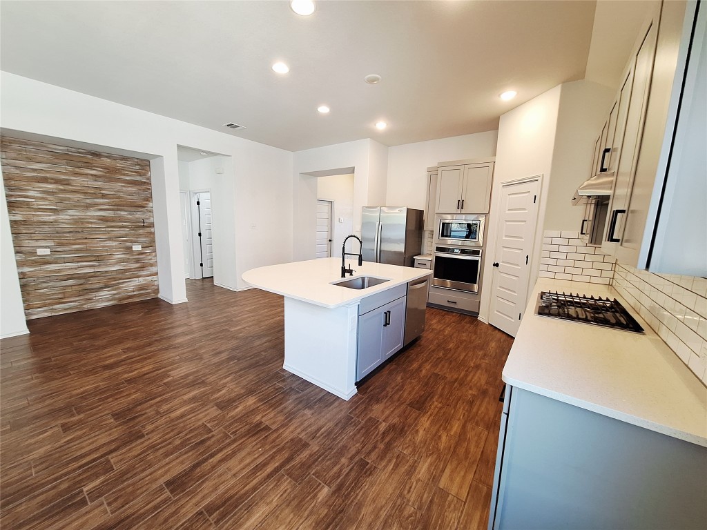 1104 River Vista Road Georgetown, TX 78628 - Photo 11 of 39 a large room with lot of wooden floor