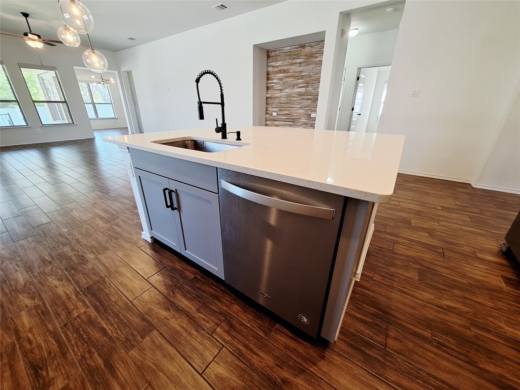 1104 River Vista Road Georgetown, TX 78628 - Photo 18 of 39 a kitchen with a sink and a wooden floor
