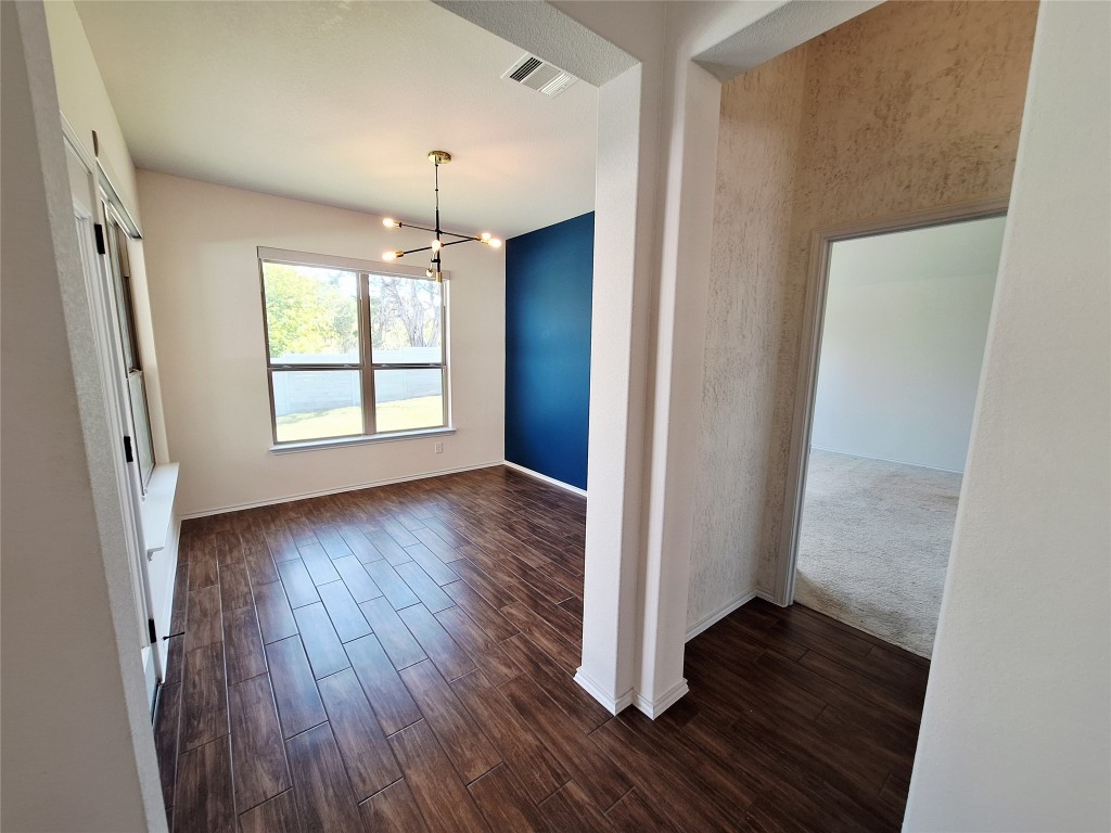 1104 River Vista Road Georgetown, TX 78628 - Photo 20 of 39 an empty room with wooden floor and windows